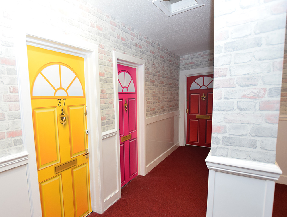 Hall of a nursing home with residents doors painted to look like a street
